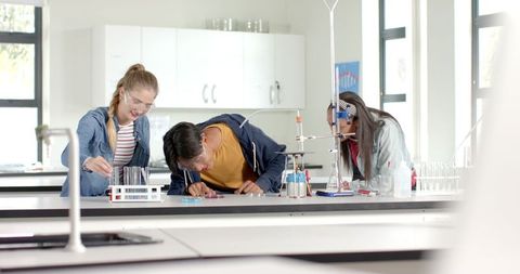 Teenagers Conducting Chemistry Experiment in High School Lab