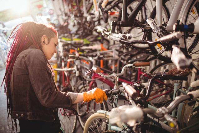 Mechanic examining bicycles in workshop