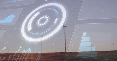 Futuristic Circular HUD Overlay in Rural Landscape with Wind Turbines