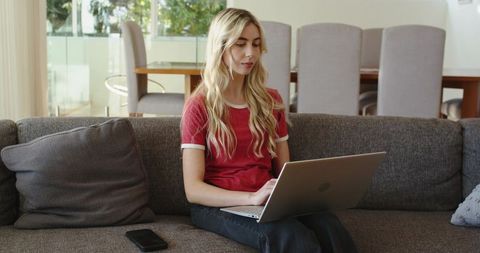 Working on Laptop from Sofa in Bright Living Room, Casual Remote Work and Productivity