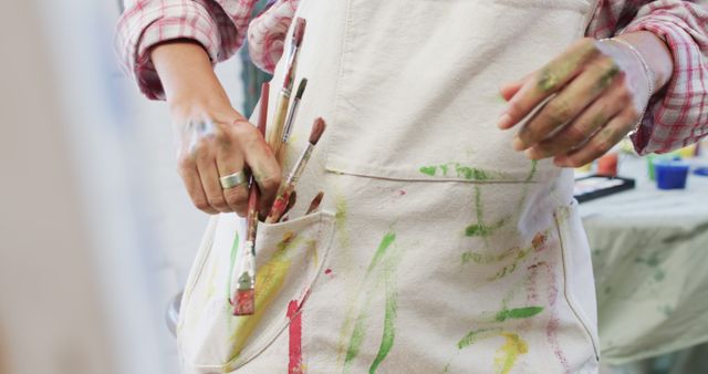 Close-Up of Painter's Apron with Brushes and Paint Stains - Download Free Stock Images Pikwizard.com