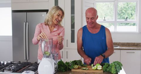 Senior Couple Preparing Nutritious Smoothies in Kitchen
