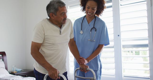 Biracial female doctor home visiting helping senior patient get up - Download Free Stock Photos Pikwizard.com