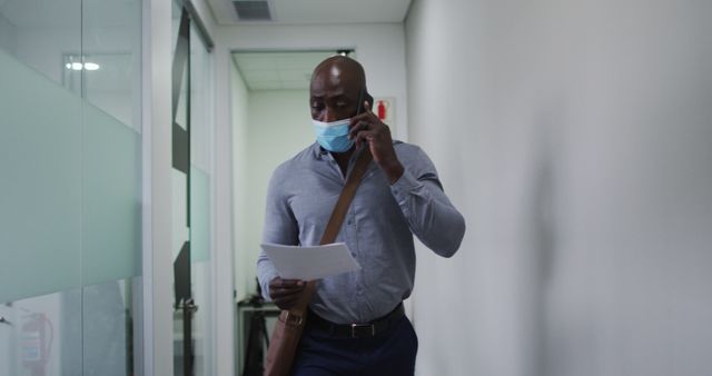 Professional Man Walking in Office Hallway Wearing Face Mask - Download Free Stock Images Pikwizard.com