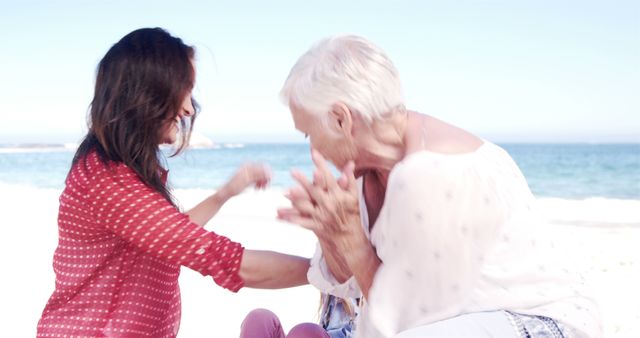 Two women laughing and enjoying time on beach, carefree joy - Download Free Stock Images Pikwizard.com