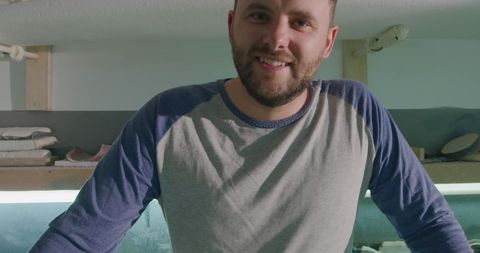 Smiling Man in Surfboard Workshop, Passionate Craftsman