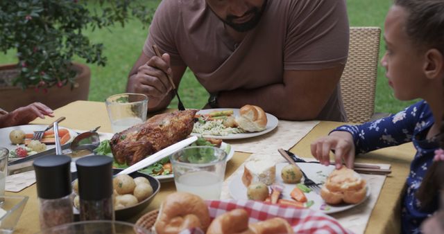 Family Eating Outdoor Lunch Together with Roasted Meat and Vegetables - Download Free Stock Images Pikwizard.com