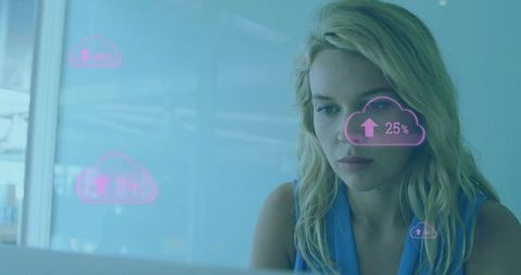 Businesswoman analyzing cloud metrics on laptop with futuristic ui overlay