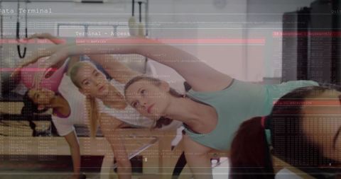 Women Stretching in Group Fitness Class with Digital Code Overlay for Tech Wellness