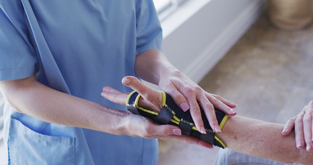 Healthcare Professional Assisting Patient with Hand Splint - Download Free Stock Images Pikwizard.com