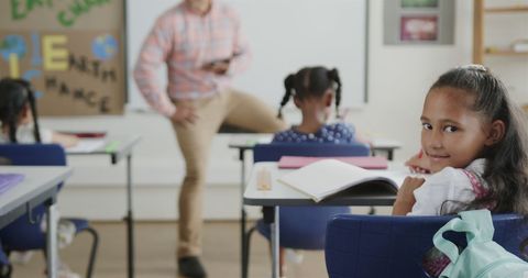 Smiling Biracial Schoolgirl in Diverse Classroom Environment - Download Free Stock Images Pikwizard.com