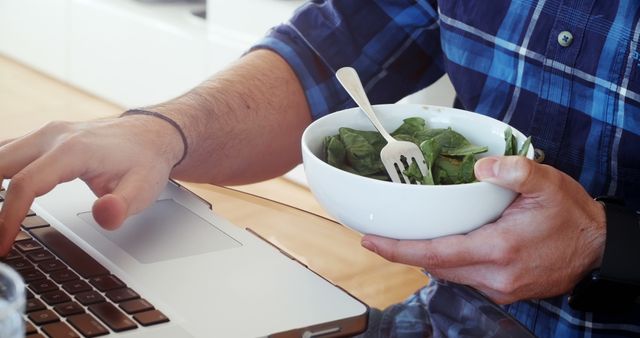 Man Working on Laptop While Eating Healthy Green Salad - Download Free Stock Images Pikwizard.com