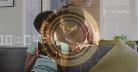 Smiling Mother and Teen Exploring Augmented Reality on Tablet in Cozy Living Room