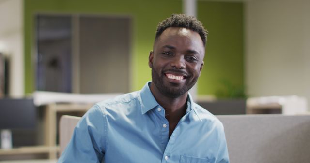 Smiling African American Man in Blue Shirt Working in Office - Download Free Stock Images Pikwizard.com