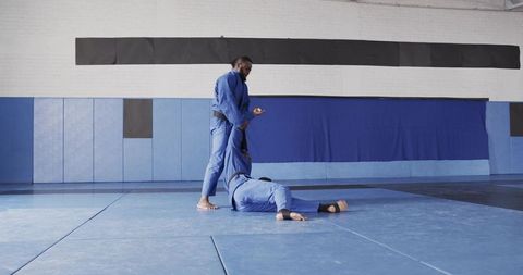 Martial arts enthusiasts engaged in grappling training at gym
