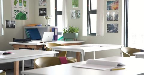 Contemporary study room with white desks and laptop