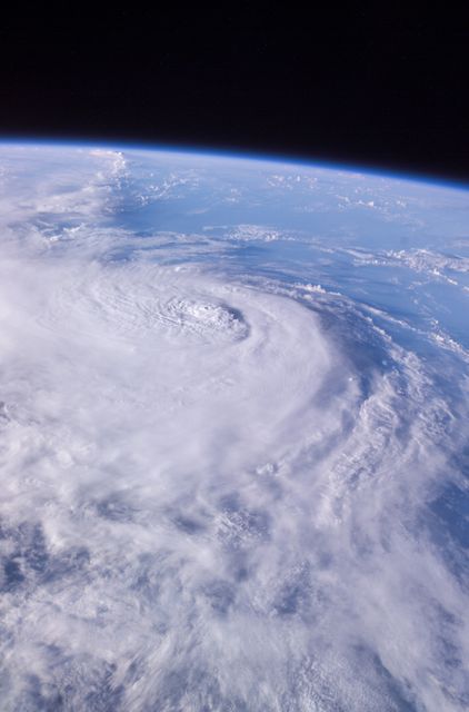 This panoramic view of Hurricane Charley was photographed by the Expedition 9 crew aboard the International Space Station (ISS) on August 13, 2004, at a vantage point just north of Tampa, Florida.  The small eye was not visible in this view, but the raised cloud tops near the center coincide roughly with the time that the storm began to rapidly strengthen.  The category 2 hurricane was moving north-northwest at 18 mph packing winds of 105 mph. Crew Earth Observations record Earth surface changes over time, as well as more fleeting events such as storms, floods, fires, and volcanic eruptions.