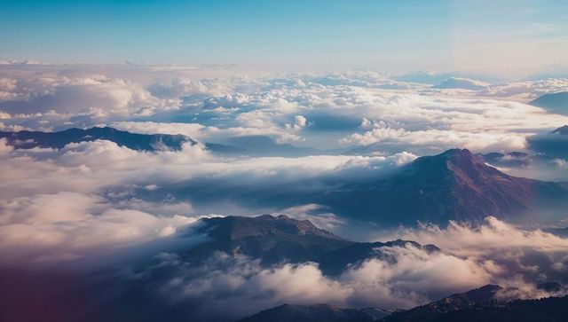 Breathtaking Aerial Mountainscape with Peaks and Clouds