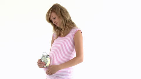 Expectant Mother Holding Alarm Clock in White Background