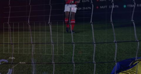 Goal net filling frame with goalkeeper diving, opponent approaching and analytics overlay