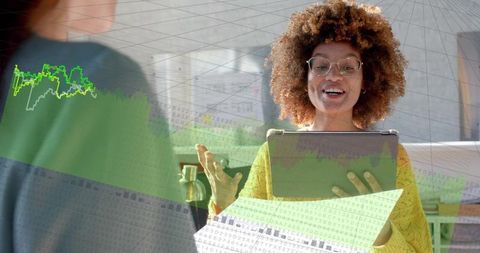 Smiling professional presenting tablet with data overlays during collaborative analytics discussion