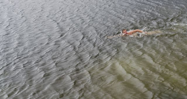 Man Swimming in Natural Lake Waters with Rippling Waves - Download Free Stock Images Pikwizard.com