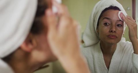 Woman with Vitiligo Practicing Skincare in Bathroom