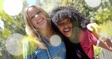 Cheerful Teenage Girls Enjoying Friendship in Sunlit Garden