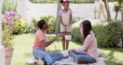 Family bonding in backyard garden during sunglossy afternoon