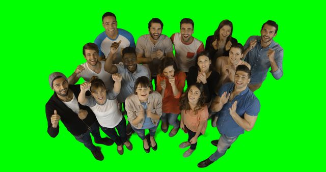 Diverse group of friends standing together, smiling and celebrating with thumbs up against a green screen background. Suitable for advertising, social media campaigns, and as a background image for presentations relating to friendship, unity, joy, and teamwork.