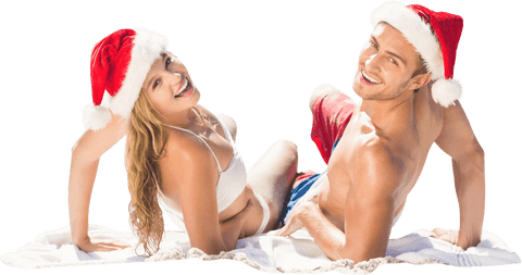 Smiling Couple in Santa Hats Celebrating Christmas on Beach