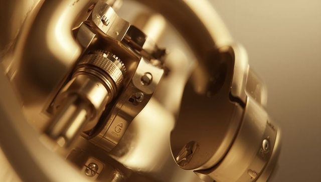 Macro brass knurled shaft revealing precision adjustment, screws and cylinder detail