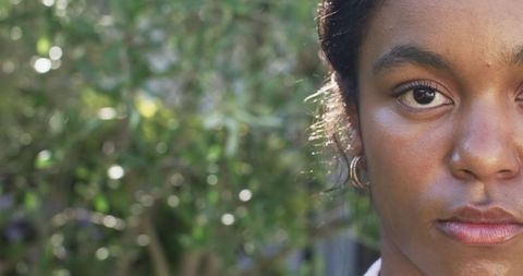 Intense Gaze of African American Woman With Sunlit Background