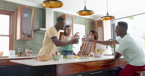 Diverse Friends Toasting in Modern Kitchen Celebration