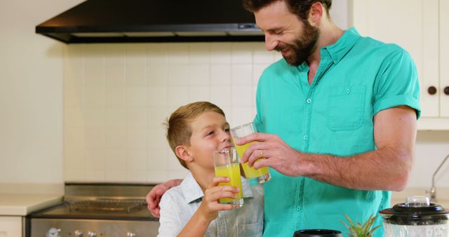 Father and Son Enjoying Fresh Juice in Kitchen - Download Free Stock Images Pikwizard.com