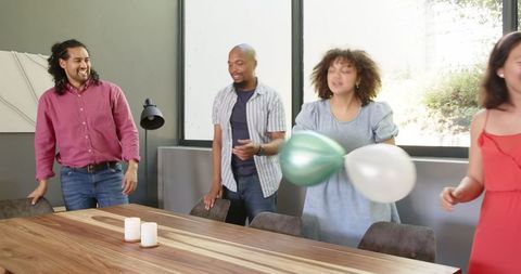 Ethnic Friends Celebrating Housewarming with Joyful Dance