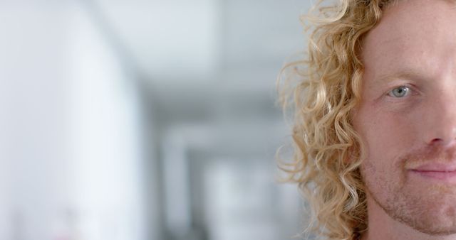Close-up of Man with Curly Blonde Hair in Contemporary Space - Download Free Stock Images Pikwizard.com