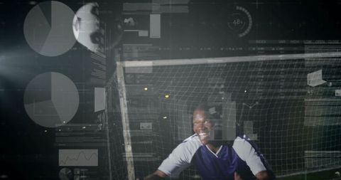 Diving goalkeeper with digital overlays during night match