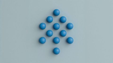 Geometric blue spheres in arrow formation on blue surface