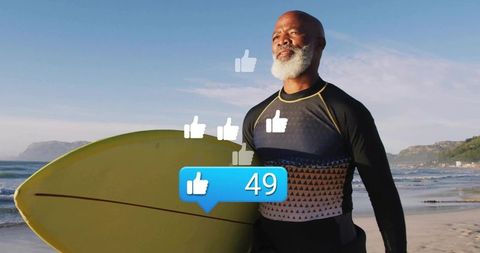 Mature surfer holding yellow surfboard gazing toward horizon with social like icons