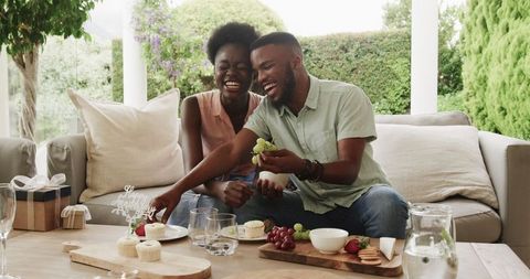 Smiling couple enjoying sweet outdoor moment with dessert and decorated table