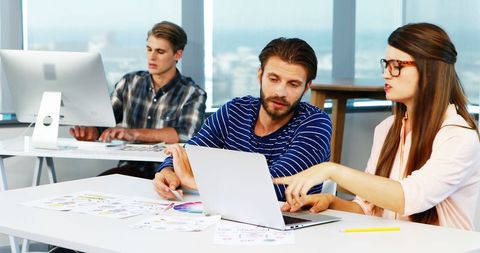 Collaborative Team of Designers Discussing Project Strategies in Office - Download Free Stock Images Pikwizard.com
