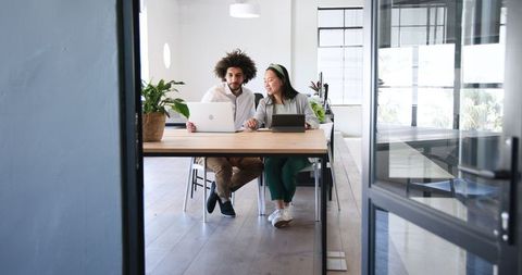 Diverse Colleagues Discussing Plans in Modern Office