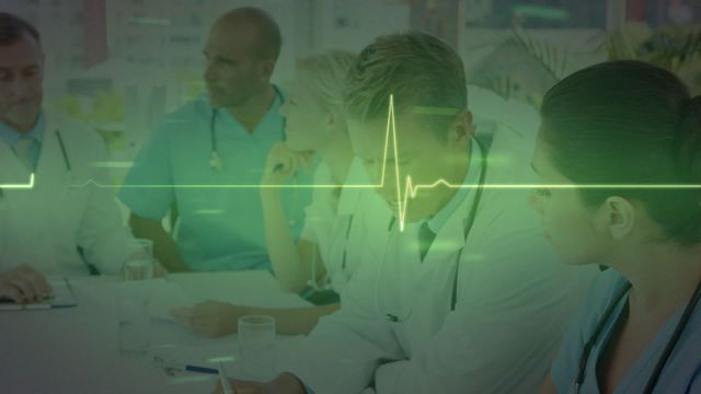 Healthcare professionals meeting in hospital environment with animated heartbeat line illustrating medical technology concept. Ideal for using in articles on healthcare innovation, teamwork in medical settings, technological advancements in medicine, or promotional materials for medical services or hospital recruitment.