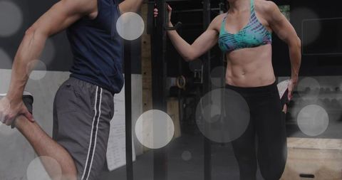 Partners stretching on pullup rig after intense workout, fitness training and teamwork