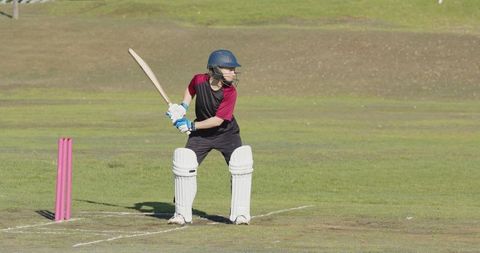 Female Cricket Player Practicing Batting on Sunny Field
