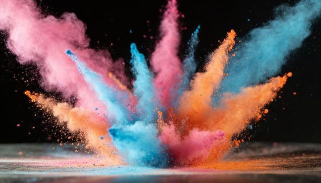 Bursting Color Powder Explosion Cyan, Pink, Orange Plumes on Dark Studio Backdrop
