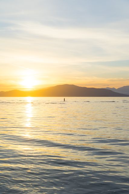 Serene Sunset Over Mountainous Horizon and Tranquil Lake - Download Free Stock Photos Pikwizard.com