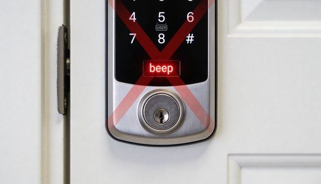 Smart deadbolt lock displaying red x warning on touchscreen keypad with metal key cylinder on white