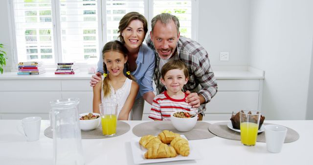 Happy Family Having Breakfast Together in Bright Modern Kitchen - Download Free Stock Images Pikwizard.com